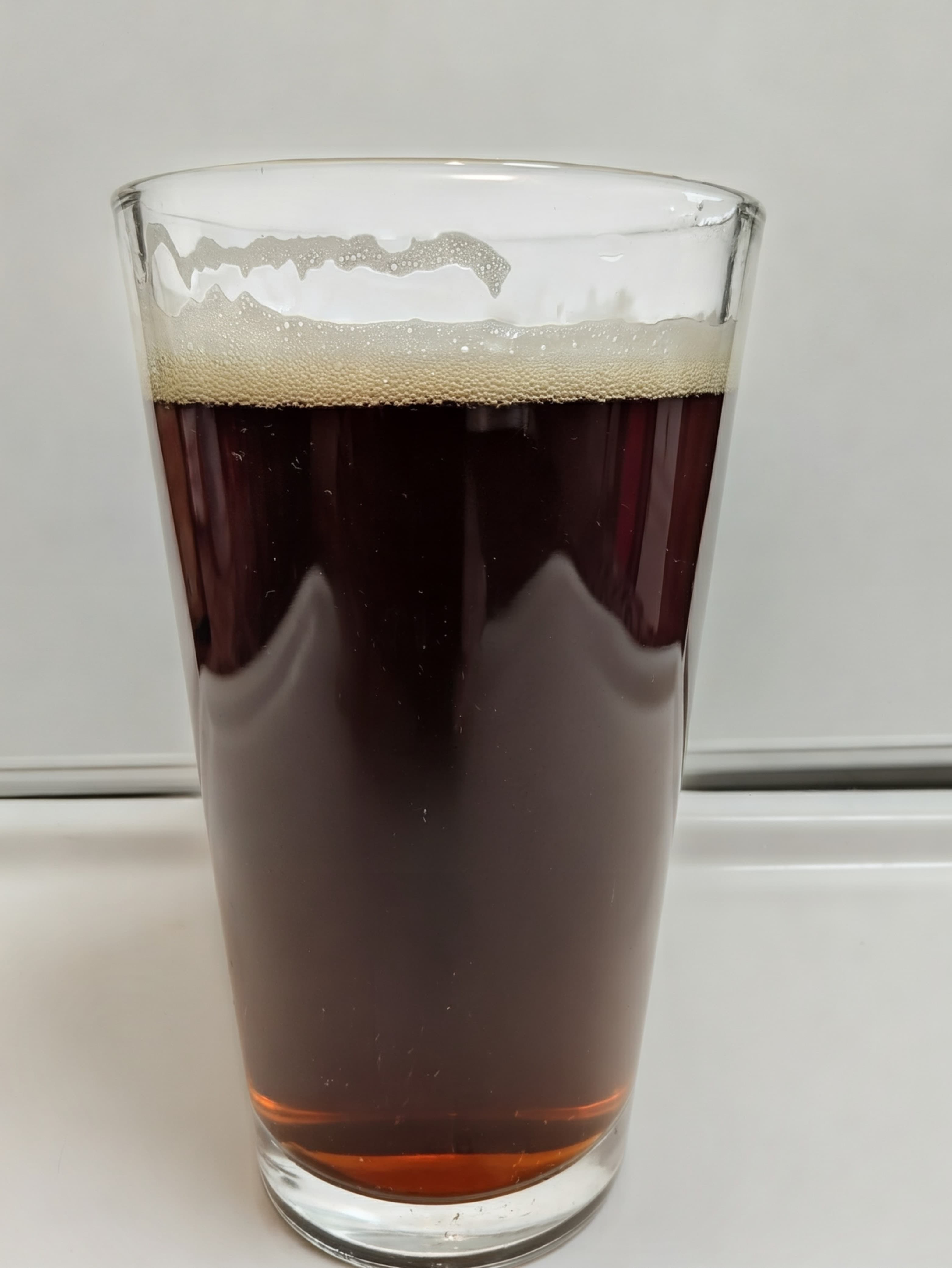 Dark ruby beer in a pint glass