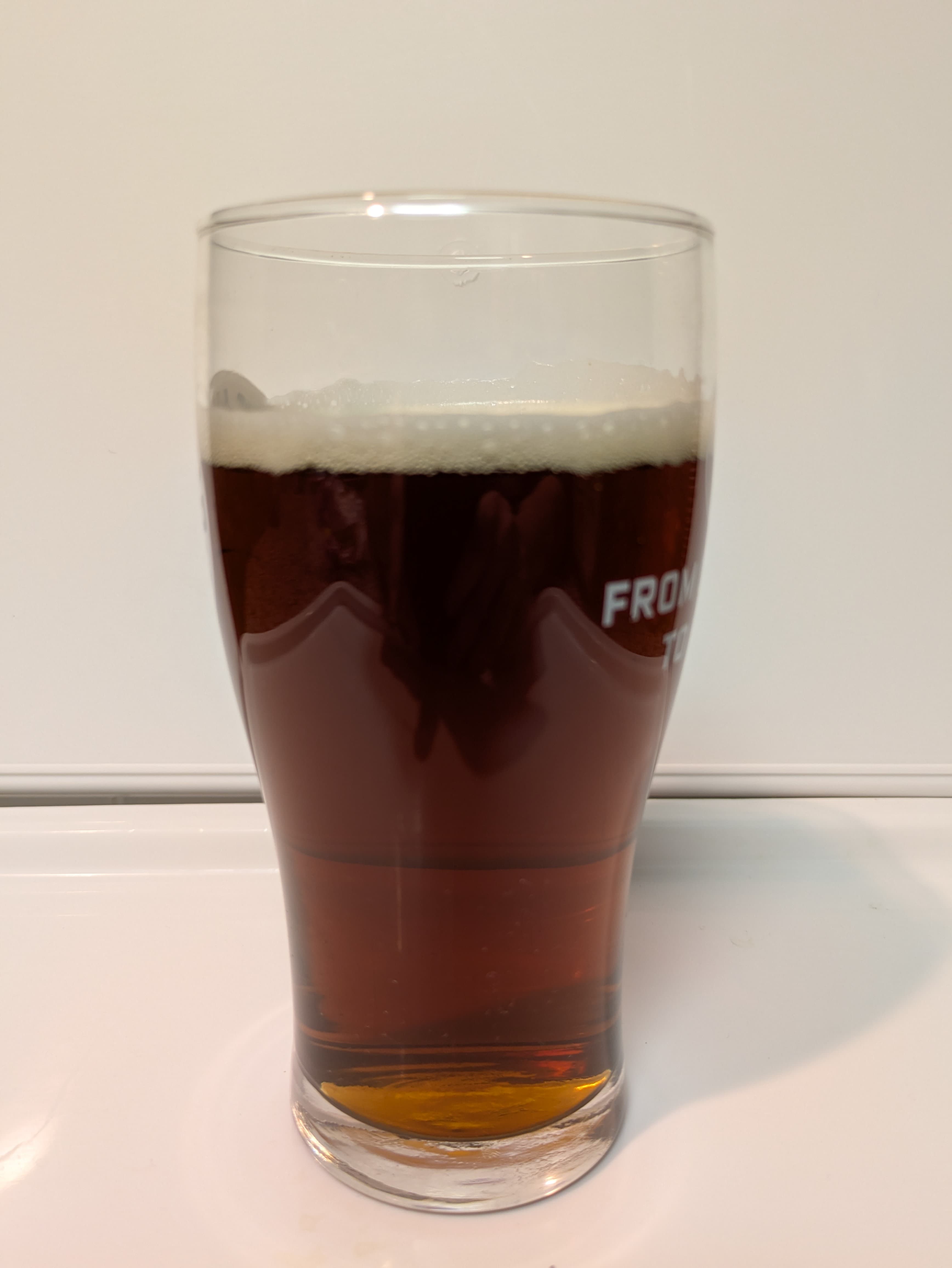 Amber colored clear beer in a glass 