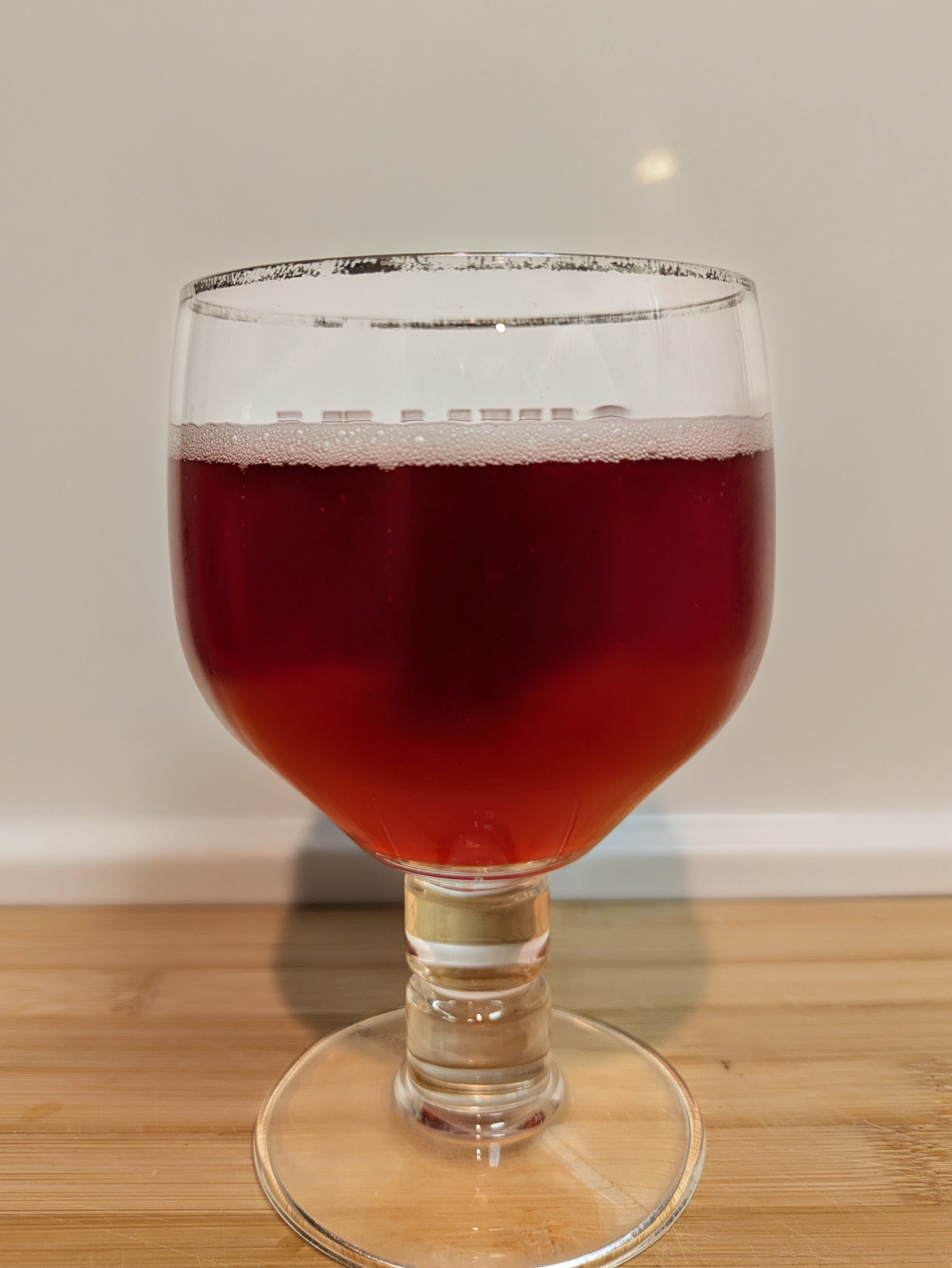 Pink-red beer in goblet-style glass